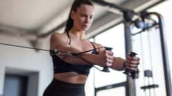 Fit,Young,Woman,Doing,Cable,Pec,Fly,Exercise,In,Gym,