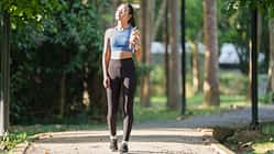 Young,Asian,Woman,,Dressed,In,Sportswear,,Walks,Along,A,Park