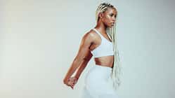African,American,Fitness,Woman,Stretching,Her,Arms,During,Workout.,Fit