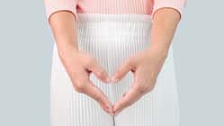 Close up view of young woman and Hand is a symbol of heart over her crotch. Feminine hygiene concept.