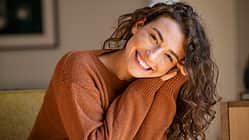 Young woman laughing while relaxing at home