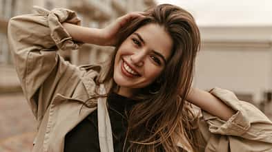 Cute,Cheerful,Lady,In,Black,Top,And,Trench,Coat,Smiles