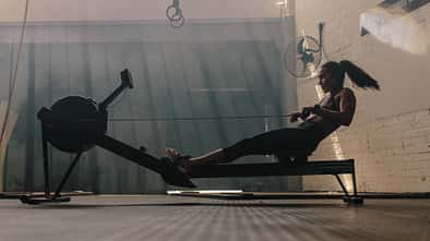 Woman,Doing,Cardio,Workout,On,Rowing,Machine,In,The,Gym.