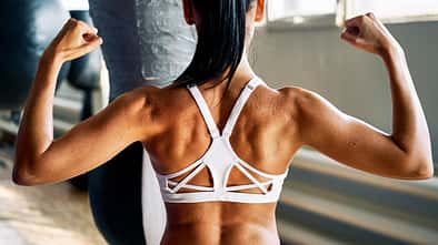 Close,Up,Of,Woman,Back,With,Flexing,Her,Muscles,In