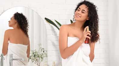 Beautiful,African-american,Woman,Spraying,Hair,In,Bathroom