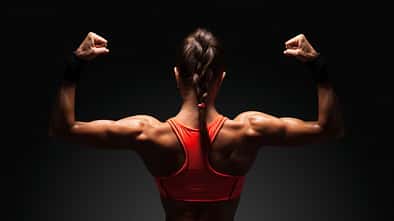 Athletic,Young,Woman,Showing,Muscles,Of,The,Back,And,Hands