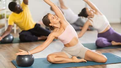 Motivated,Young,Girl,Performing,Mermaid,Stretch,With,Ball,In,Group