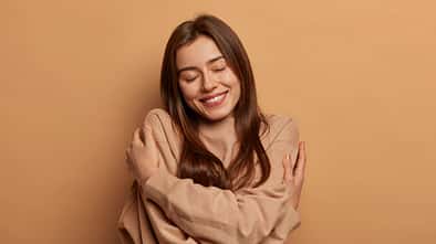 I,Love,Myself.,Pretty,Smiling,Woman,Embraces,Herself,Gently,,Expresses