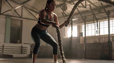 Young,Woman,Doing,Strength,Training,Using,Battle,Ropes,At,The