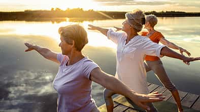 Group,Of,Senior,Woman,Doing,Yoga,Exercises,By,The,Lake.