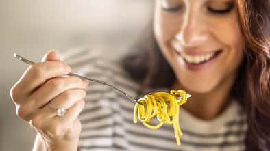 Young,Woman,Enjoys,Eating,Spaghetti.,He,Has,Aglio,E,Olio