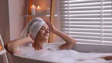 Glückliche Frau in der Badewanne