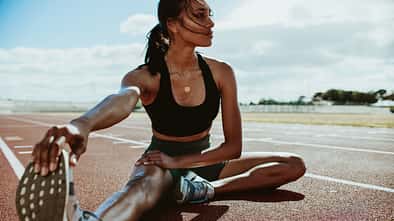 away,woman,young,exercise,training,body,stretching,fit,running,s Athlete,Doing,Stretching,Exercises,On,Running,Track.,Woman,Runner,Stretching