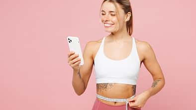 Young,Woman,Wears,White,Top,Casual,Clothes,Hold,Measure,Tape