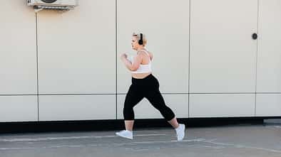 Side,View,Of,A,Woman,With,Plus,Size,Body,Running