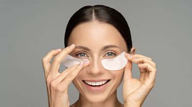 Happy,Woman,Applying,Hydrogel,Under-eye,Recovery,Patches,Enriched,With,Collagen,