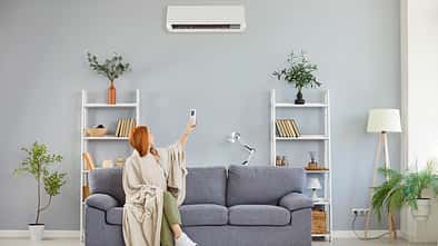 electronics,feel,conditioner,inside,remote,at home,center climat Girl,Wrapped,In,Blanket,Switching,On,,Off,Air,Conditioner,,Blowing