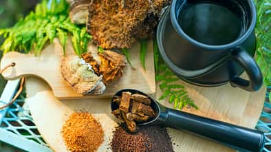 Chaga mushroom. Mushroom coffee chaga superfood. Dried mushrooms and and a cup of coffee. Healthy organic energizing adaptogen, endurance boosting food trends.