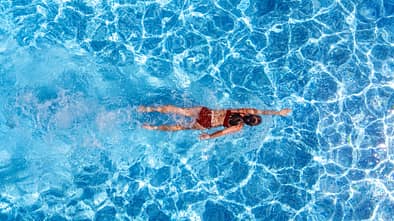 Active,Girl,In,Swimming,Pool,Aerial,Drone,View,From,Above,