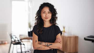 Portrait of a beautiful young asian woman standing in living room