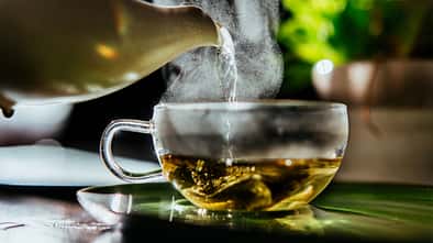 Fresh hot water for organic sage herbal tea at teatime.