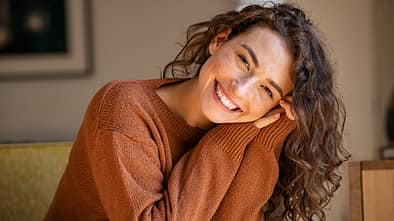 Young woman laughing while relaxing at home