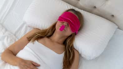 Woman using mouth tape to promote nasal breathing.