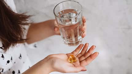 Diet.,Nutrition.,Girl's,Hands,With,Pills,With,Cod,Liver,Omega-3
