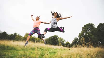 Sporty women jumping together Sporty women jumping together