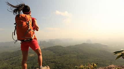 Successful,Woman,Hiker,Enjoy,The,View,On,Mountain,Top,Cliff