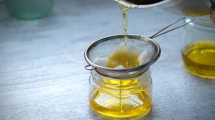 container,taste,preparation,fat,golden,jet,clarified butter,jar, The,Oil,Is,Filtered,Into,A,Glass,Jar,Through,A