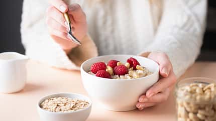 berry,hands,caucasian,prepared,blonde,dieting,red,white,fitness, Young,Woman,Eating,Oatmeal,Porridge,With,Raspberries.,Healthy,Vegan,Nutritious