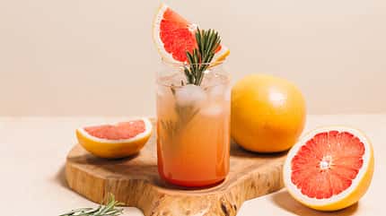 Grapefruit,Cocktail,With,Rosemary,Garnish,In,A,Glass,,Served,On