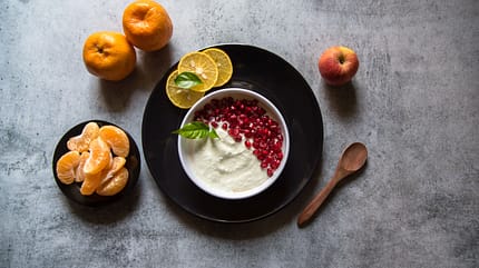 half,gourmet,black plate,curd,freshness,dieting,top view food,re Leaf,On,Curd,And,Pomegranate,Seeds,With,Use,Of,Selective