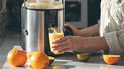 glass,woman,homemade,fruit,electric,health,vegan,juice,drink,foo A,Woman,Makes,Orange,Juice,At,Home,In,The,Kitchen