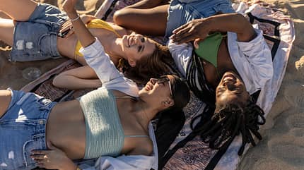 friendship,caucasian,happy,young adult,american,three,horizontal Three,Diverse,Female,Friends,Lie,On,The,Beach,At,Sunset