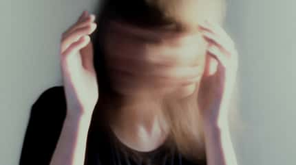 Young woman moving her head fast, long exposure surreal portrait Young woman moving her head fast, long exposure surreal portrait