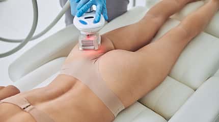 Woman with beautiful body receiving anti-cellulite and anti-fat therapy in spa salon Woman with beautiful body receiving anti-cellulite and anti-fat therapy in spa salon