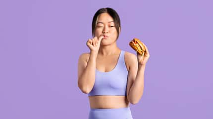 Fit,Asian,Woman,In,Workout,Clothing,,Looking,At,Tasty,Burger