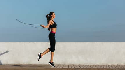 Young woman training with a jumping rope