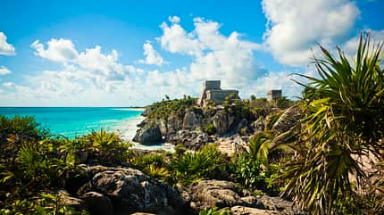 "Stone,Looking Over,Antiquities,Tulum,Archaeology,Mayan,Latin American Civilizations,Scenics,Construction Site,Ruined,Past,Blue,Ancient,Traditional Culture,Local Landmark,International Landmark,National Landmark,Famous Place,Tropical Climate,Outdoors,Quintana Roo,El Castillo,Yucatan,Yucatan Peninsula,Mexico,Palm Tree,Plant,Cliff,Sky,Sea,Flowing Water,Water's Edge,Wave,Water,Temple,Monument,Old Ruin,Ripple,Travel Locations,Landmarks" Tulum, Mexico