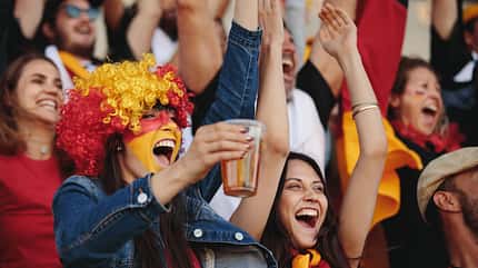 german,game,flag,crowd,young,yelling,germany,yellow,paint,enjoyi Woman,In,Fan,Zone,With,A,Wig,And,Face,Painted