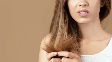 Frustrated,Young,Woman,Having,Problem,With,Split,Ends,On,Brown