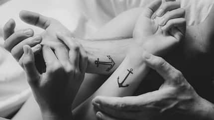 Woman's,And,Man's,Hands,With,Tattoo,Together