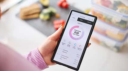 Close,Up,Of,Woman,Looking,At,Calorie,Counting,App,On