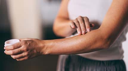 Close-Up of Woman Applying Moisturizer on Her Arm for Skincare Close-Up of Woman Applying Moisturizer on Her Arm for Skincare