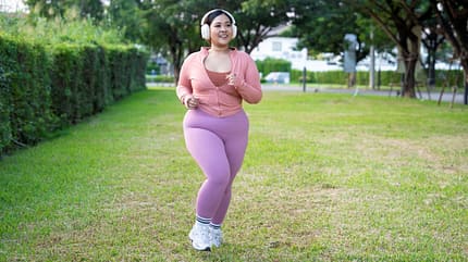 Eine kurvige Frau joggt draußen Eine kurvige Frau joggt draußen