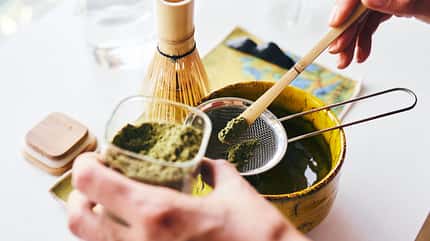 Preparing Matcha Tea with Traditional Tools in a Bright Setting