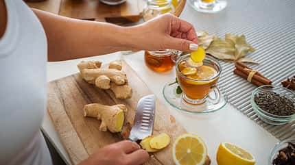 Woman preparing ginger and lemon hot tea Woman preparing ginger and lemon hot tea