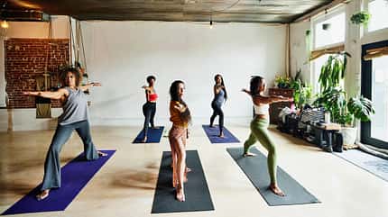 Frauen praktizieren Yogaübungen auf Yogamatten Frauen praktizieren Yogaübungen auf Yogamatten